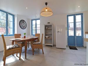 a dining room with a table and a refrigerator at Gîte Sap-en-Auge, 4 pièces, 5 personnes - FR-1-497-146 in Le Sap