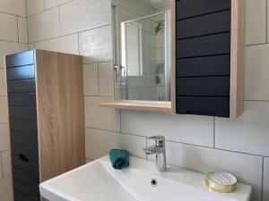 a bathroom with a sink and a mirror at Gîte champêtre rénové avec jardin et équipements modernes à Pierrefitte-sur-Loire - FR-1-489-334 in Pierrefitte-sur-Loire +13 photos