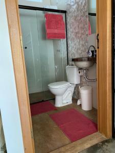 a bathroom with a toilet and a sink at Amanduarte Brasília in Brasilia