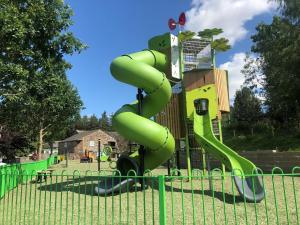 a playground with a green slide in a park at Parklands in Penrith