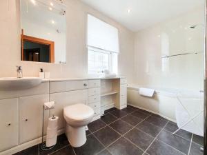 a white bathroom with a toilet and a sink at Parkgate Apartment - Near M90, Amazon, Edinburgh in Rosyth