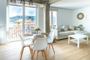 a living room with a table and chairs and a couch at Mundaka Centre by Urdaibai Rentals in Mundaka