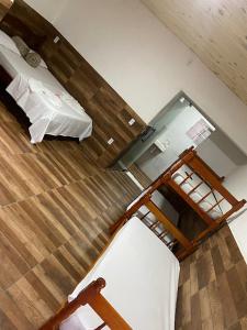 an overhead view of a room with a bed and a ladder at Pesque pague pousada do Carlinho in Pinheiral