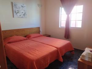 Ένα ή περισσότερα κρεβάτια σε δωμάτιο στο apartamentos la villa