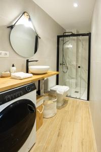 a bathroom with a shower and a sink and a dishwasher at Mundaka Centre by Urdaibai Rentals in Mundaka +26 photos