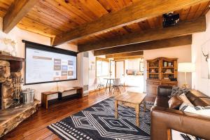 a living room with a couch and a large screen at Amazing Cabin - Close To Ski Resort and Village in Big Bear Lake