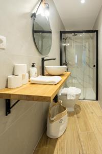 a bathroom with a sink and a toilet and a mirror at Mundaka Centre by Urdaibai Rentals in Mundaka