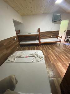 a room with two beds and a tv in it at Pesque pague pousada do Carlinho in Pinheiral