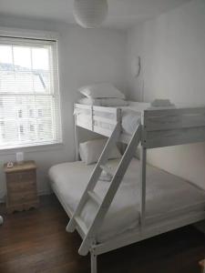 a bedroom with two bunk beds and a window at University and Central Edinburgh in Edinburgh