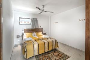 a bedroom with a bed and a ceiling fan at Hotel Europalace in Playa del Ingles +45 photos