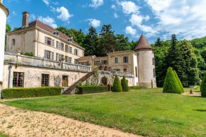 an estate with a turret and green lawn at Château de Pramenoux in Lamure-sur-Azergues