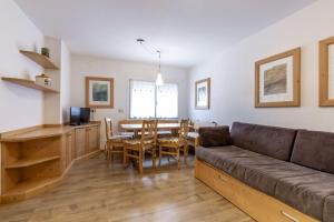 a living room with a couch and a table at Stella Alpina in Campitello di Fassa