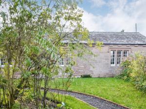 an old brick house with a garden in front of it at Biskey Howe in Newby