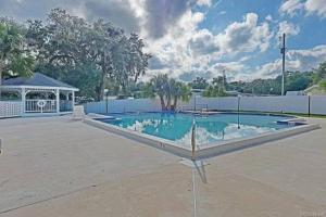 a large swimming pool in a parking lot at Cypress Cove Waterfront Townhome with Boat Ramp in Inverness