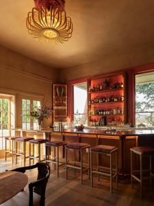 a bar with stools and a chandelier at The Madrona in Healdsburg