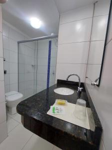 a bathroom with a sink and a toilet at Hotel Vela Azul in Balneário Camboriú +64 photos