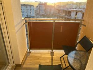a balcony with a table and chairs on a building at Apartman Gavric 2 in Doboj