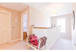 a room with a chair with a pillow on it at Modern Homestay 15 minutes to Dublin Airport in Ballyboughal
