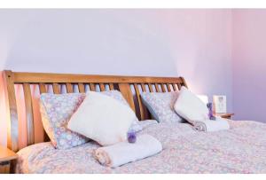 a bed with two pillows on top of it at Modern Homestay 15 minutes to Dublin Airport in Ballyboughal