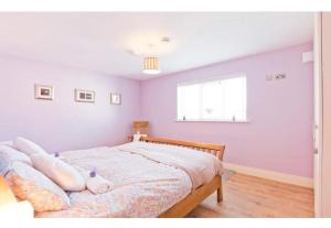 a bedroom with a bed with a pig pillow on it at Modern Homestay 15 minutes to Dublin Airport in Ballyboughal
