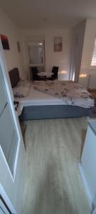 a bedroom with a bed and a table in it at Apartman Gavric 2 in Doboj