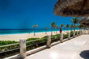 a view of a beach with palm trees and the ocean at Ocean view apartment, best beach area, 3 bedrooms in Cancún