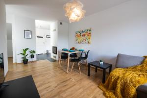 a living room with a table and a couch at Halna Residence in Krynica Zdrój