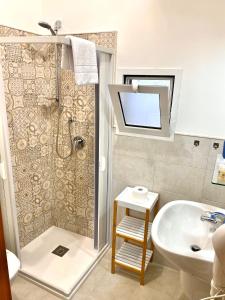 a bathroom with a shower and a sink and a toilet at Ginevra Rooms in Bari +23 photos