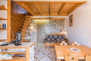 a living room with a table and a wooden ceiling at Charming apartment with view on the Mont Blanc - Welkeys in Megève