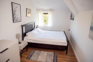 a small bedroom with a bed and a window at Mountain Chalet Kopaonik in Kopaonik