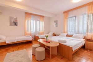 a living room with two beds and a table at Apartments Serafimoski in Ohrid