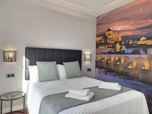 1 dormitorio con 1 cama grande y una pintura en la pared en Victoria Cordoba Center, en Córdoba