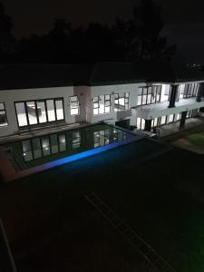 an exterior view of a building at night at Bryanston Drive Elegant Guesthouse & Boardroom Facilities in Johannesburg