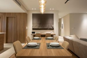 a dining room with a table and a couch at New Cairo, Akoya Residence, Milena in New cairo