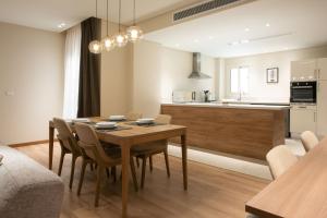 a kitchen and dining room with a table and chairs at New Cairo, Akoya Residence, Milena in New cairo +4 photos