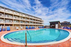 a large swimming pool in front of a hotel at Ocean Breezes 863 #110DS-H in Hatteras