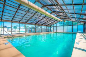 a large indoor swimming pool with blue water at The Bluffs Lakeview in Branson