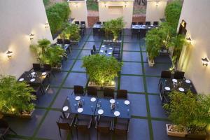 una vista sul soffitto di un ristorante con tavoli e sedie di Hotel Shlok- Pure Veg , Kolhapur a Kolhapur