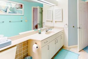 a bathroom with a sink and a mirror at South Beach 53 in Glen Arbor +11 photos