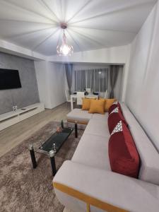 a living room with two couches and a tv at DREAMS ESCAPE 2 in Craiova