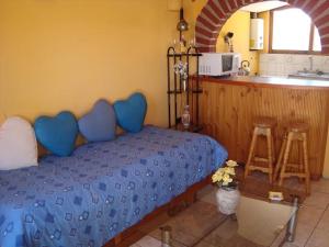 a bedroom with a blue bed and a kitchen at casa norma santiago 5 personas in Santiago