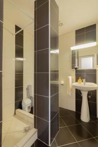 a bathroom with a shower and a sink and a toilet at Apartments Serafimoski in Ohrid