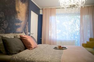 a bedroom with a bed with a plate of food on it at Le Boudoir, Centre ville, Parking couvert inclus in Mulhouse