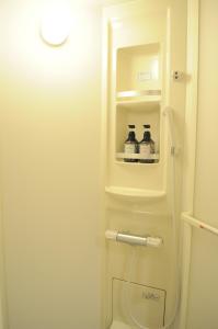 a small white refrigerator with two bottles of water at 04 village Namba - Vacation STAY 37120v in Osaka