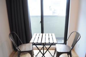a table and two chairs in front of a window at 04 village Namba - Vacation STAY 37120v in Osaka