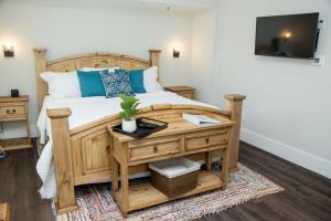 a bedroom with a wooden bed with a wooden desk at Pomar House in St. Augustine