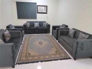 a living room with couches and a projection screen at Al Basam Furnished Units in Yanbu