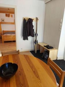 a room with a wooden table and a room with a bed at Bel appartement dans une ferme Vosgienne in Xonrupt-Longemer