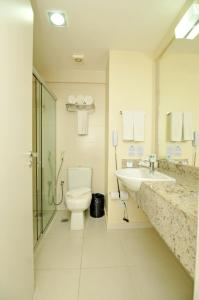 a bathroom with a toilet and a sink at Holiday Inn Express Belem Ananindeua, an IHG Hotel in Belém