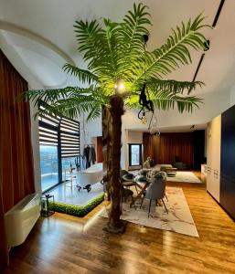 a living room with a palm tree in the middle at ROOF TOP LUXURY in Blagoevgrad